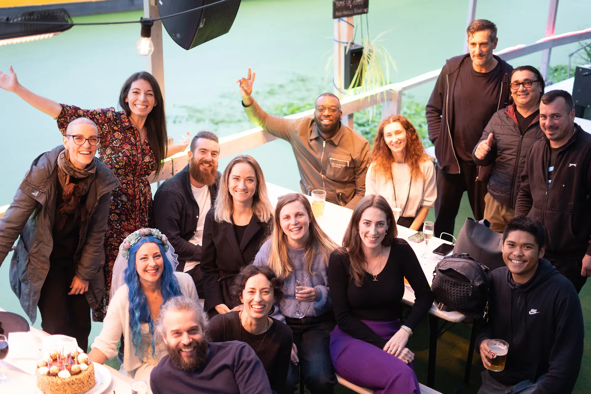 Happy group of people next to a river, smiling at the camera