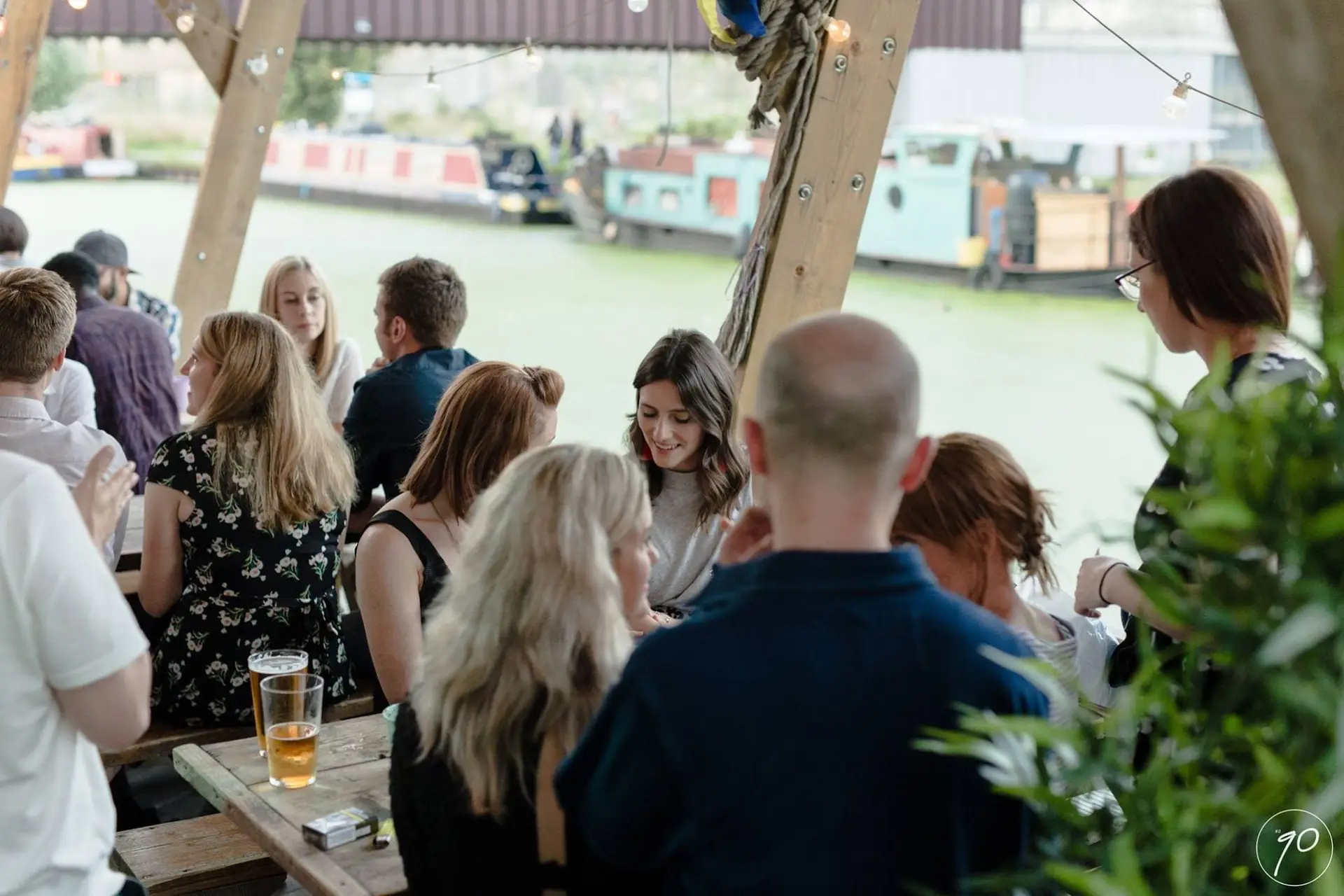 Canal-side bar restaurant No90 Hackney Wick terrace busy with people eating and drinking