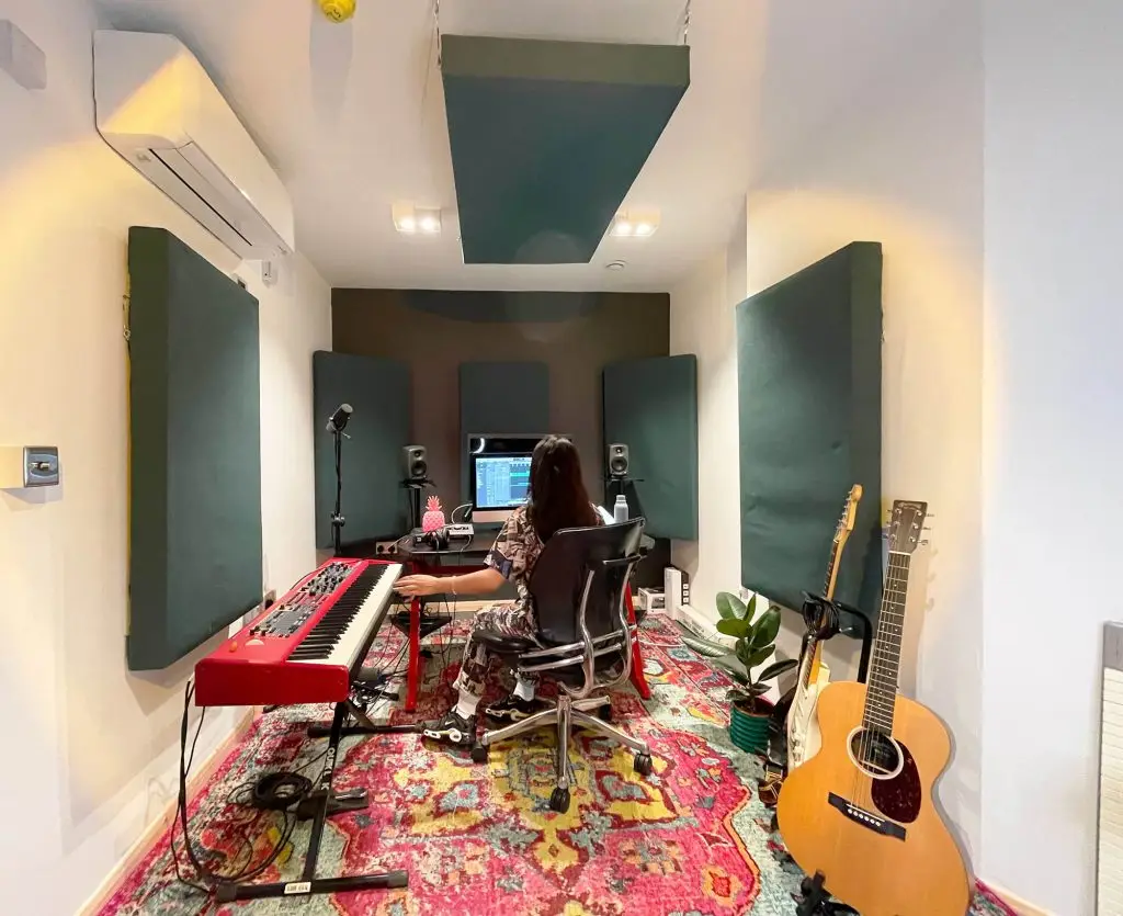Creative musician's soundproof studio in Mainyard Studios, Hackney, with guitars, keyboards, and recording equipment.