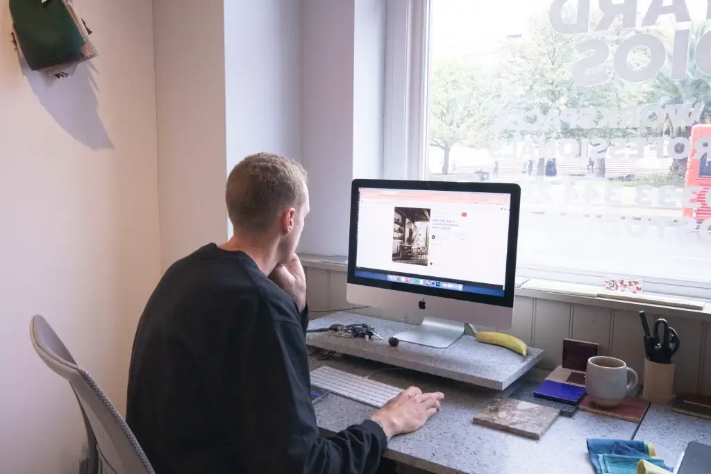 Person working on a desktop computer in a bright creative studio at Mainyard Studios Hackney Wick