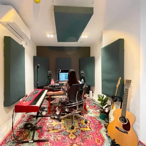 Creative musician's soundproof studio in Mainyard Studios, Hackney, with guitars, keyboards, and recording equipment.